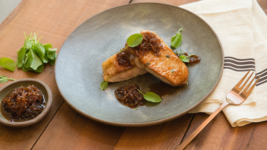 Boneless Pork Chops with Sweet Apple and Onion Sauce on a plate